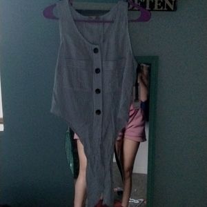 A blue Shirl that ties in the front with brown buttons